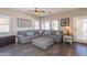 Comfortable living room with a sectional sofa, ceiling fan, and ample natural light at 7670 W Sands Dr, Peoria, AZ 85383