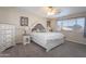 Serene main bedroom with a decorative headboard, neutral decor, and natural light at 7670 W Sands Dr, Peoria, AZ 85383