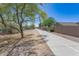 Community walking path featuring lush desert trees, shrubs and plants bordering block wall homes at 7670 W Sands Dr, Peoria, AZ 85383