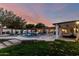 A serene backyard with a sparkling pool, spa, outdoor kitchen, and lush landscaping under a colorful sky at 8031 N 12Th Ave, Phoenix, AZ 85021
