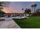 Dusk view of the backyard featuring a pool, spa, and outdoor living areas at 8031 N 12Th Ave, Phoenix, AZ 85021