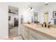 Well-lit bathroom with double sinks, a large mirror, and a doorway to the bedroom at 8031 N 12Th Ave, Phoenix, AZ 85021