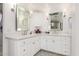 Elegant bathroom with dual sinks, large mirrors, and white cabinets at 8031 N 12Th Ave, Phoenix, AZ 85021