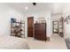 Bedroom with a large dresser, ceiling fan, and shelving unit at 8031 N 12Th Ave, Phoenix, AZ 85021