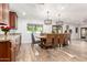 Bright dining room with a large wooden table, wicker chairs, and stylish light fixtures at 8031 N 12Th Ave, Phoenix, AZ 85021