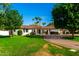Inviting single-story home with lush lawn, mature trees, and brick driveway at 8031 N 12Th Ave, Phoenix, AZ 85021