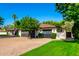 Well-maintained single-story home with an attached garage and brick driveway at 8031 N 12Th Ave, Phoenix, AZ 85021