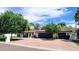 Beautiful single-story home with lush landscaping, brick driveway, and attached garage at 8031 N 12Th Ave, Phoenix, AZ 85021