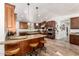 Spacious kitchen with granite countertops, wooden cabinets and a center island with seating at 8031 N 12Th Ave, Phoenix, AZ 85021