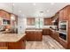 Spacious kitchen features wood cabinets, granite countertops, stainless steel appliances and an island at 8031 N 12Th Ave, Phoenix, AZ 85021