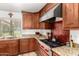 Modern kitchen features stainless steel range hood, gas range and granite countertops at 8031 N 12Th Ave, Phoenix, AZ 85021
