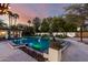 Lush backyard features a stunning pool with rock detail, pergola, and landscaped yard perfect for relaxation at 8031 N 12Th Ave, Phoenix, AZ 85021