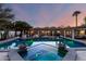 Inviting pool and spa at dusk, complemented by outdoor kitchen, pergola, and fire pit for entertaining at 8031 N 12Th Ave, Phoenix, AZ 85021