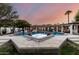Backyard pool and hot tub featuring well-lit spaces and landscaping at dusk at 8031 N 12Th Ave, Phoenix, AZ 85021