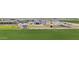 Aerial view of the property featuring the home, horse facilities, outbuildings, and green fields at 8429 S 229Th Ln, Buckeye, AZ 85326