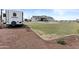 View of the rear of the house, patio, Winnebago, and the expansive, well-maintained backyard at 8429 S 229Th Ln, Buckeye, AZ 85326