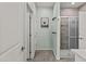 Bathroom with wood-look tile floors and a glass-enclosed shower with stylish tile surround at 8429 S 229Th Ln, Buckeye, AZ 85326