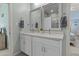 Bright bathroom featuring a double vanity with white cabinets, framed mirrors, and modern fixtures at 8429 S 229Th Ln, Buckeye, AZ 85326