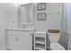 Bathroom with a modern vanity, decorative mirror, and playful wall art at 8429 S 229Th Ln, Buckeye, AZ 85326