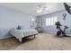 Comfortable bedroom with blue walls, plush carpet, and a ceiling fan at 8429 S 229Th Ln, Buckeye, AZ 85326
