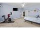 Well-lit bedroom with calming blue walls, plush carpet, and a Peloton exercise bike at 8429 S 229Th Ln, Buckeye, AZ 85326