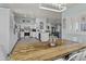 Dining area featuring a rustic wood table, white chairs, and natural light at 8429 S 229Th Ln, Buckeye, AZ 85326