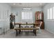 Dining room featuring a large table with bench seating and modern light fixture at 8429 S 229Th Ln, Buckeye, AZ 85326