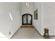 Elegant entryway features a beautiful, ornate iron front door and striking overhead lighting at 8429 S 229Th Ln, Buckeye, AZ 85326