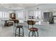 Kitchen island with barstool seating and quartz countertops at 8429 S 229Th Ln, Buckeye, AZ 85326