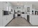Bright kitchen featuring white cabinetry, stainless steel appliances, and tile flooring at 8429 S 229Th Ln, Buckeye, AZ 85326