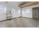 Bright living room with laminate wood flooring, a window, and shelving at 8429 S 229Th Ln, Buckeye, AZ 85326