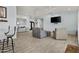 Spacious living room with tile flooring, ceiling fans, modern furniture, and a mounted TV at 8429 S 229Th Ln, Buckeye, AZ 85326