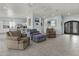 Open-concept living room showcasing comfortable seating, tile floors, and views into the kitchen at 8429 S 229Th Ln, Buckeye, AZ 85326