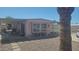 Charming single-story home with a covered front porch and desert landscaping at 8609 E Dewberry Ave, Mesa, AZ 85208