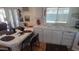 Cozy kitchen features a dining area with a white tile countertop and ample storage at 8609 E Dewberry Ave, Mesa, AZ 85208