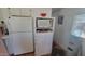 Bright kitchen with white appliances, including a refrigerator and microwave on shelving at 8609 E Dewberry Ave, Mesa, AZ 85208
