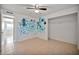 Bedroom featuring a ceiling fan and empty closet, ready for personalization at 9102 N 56Th Ln, Glendale, AZ 85302