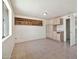 Spacious bonus room features tile flooring, built-in shelves, cabinets, and ample natural light at 9102 N 56Th Ln, Glendale, AZ 85302