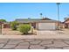 Ranch-style home with two-car garage, desert landscaping, and inviting curb appeal under a clear blue sky at 9102 N 56Th Ln, Glendale, AZ 85302