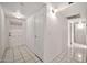 Clean hallway showcasing tiled flooring and multiple doorways at 9102 N 56Th Ln, Glendale, AZ 85302