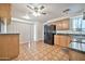 Kitchen area features wood cabinets, black appliances, and a sliding glass door for convenient access at 9102 N 56Th Ln, Glendale, AZ 85302