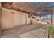 Covered pergola on a concrete patio provides a shady outdoor space at 9102 N 56Th Ln, Glendale, AZ 85302