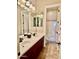 Bathroom with double sinks, cherry cabinets, a large mirror, and a separate shower-tub area at 9249 E Desert Arroyos St, Scottsdale, AZ 85255