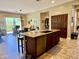 Eat-in kitchen featuring large island, dark wood cabinets and stainless steel dishwasher at 9249 E Desert Arroyos St, Scottsdale, AZ 85255