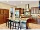 Spacious eat-in kitchen with large island, stainless refrigerator, granite countertops and dark wood cabinets at 9249 E Desert Arroyos St, Scottsdale, AZ 85255