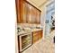 Butler's pantry featuring wine refrigerator, granite countertops and custom cabinets at 9249 E Desert Arroyos St, Scottsdale, AZ 85255