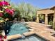 Beautiful backyard pool with water feature, stone decking and covered patio and landscaping at 9249 E Desert Arroyos St, Scottsdale, AZ 85255
