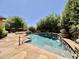 Sparkling pool featuring stone waterfall feature and a beautiful, landscaped backyard at 9249 E Desert Arroyos St, Scottsdale, AZ 85255