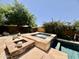 An in-ground spa with stone trim sits near a pool with water feature in a landscaped backyard at 9249 E Desert Arroyos St, Scottsdale, AZ 85255