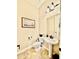 Compact powder room features a pedestal sink, toilet, modern lighting, and decorative mirror at 9249 E Desert Arroyos St, Scottsdale, AZ 85255